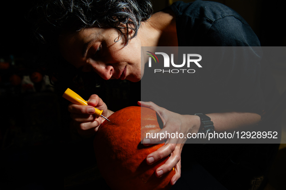 A woman carves a pumpkin for the Halloween celebration in the Netherlands, on October 30, 2025.  by Romy Arroyo Fernandez/NurPhoto