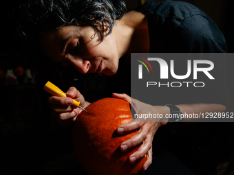 A woman carves a pumpkin for the Halloween celebration in the Netherlands, on October 30, 2025.  by Romy Arroyo Fernandez/NurPhoto