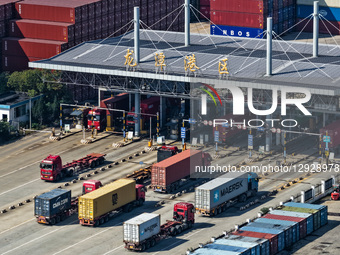 Trucks transport containers in Longtan Port Area of Nanjing Port, Nanjing City, Jiangsu Province, China, on October 31, 2025.  by Costfoto/NurPhoto