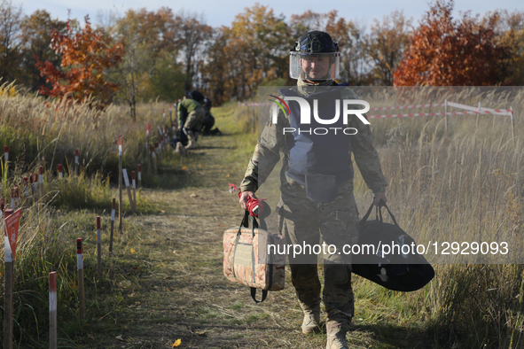 A participant carries equipment during humanitarian demining training for war veterans in Kyiv, Ukraine, on October 30, 2025. Ukrainian war... by Yuliia Ovsiannikova/Ukrinform/NurPhoto