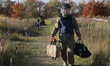 A participant carries equipment during humanitarian demining training for war veterans in...