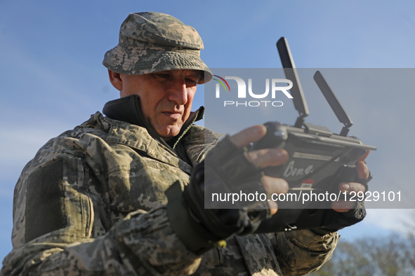 A participant uses a remote control to operate an unmanned ground vehicle (UGV) that carries equipment during humanitarian demining training... by Yuliia Ovsiannikova/Ukrinform/NurPhoto