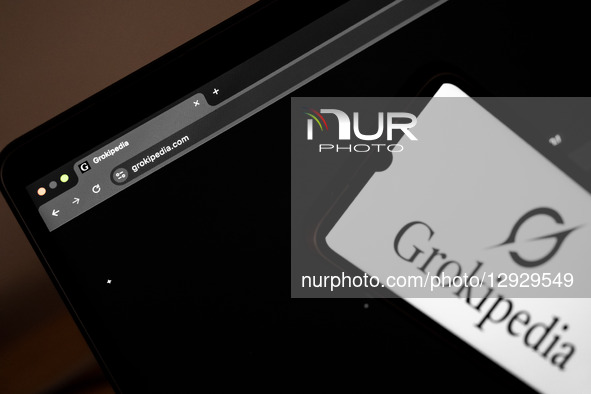 The Grokipedia website appears on a laptop computer screen, and the Grokipedia logo appears on a smartphone screen, in this photo illustrati... by Nikolas Kokovlis/NurPhoto