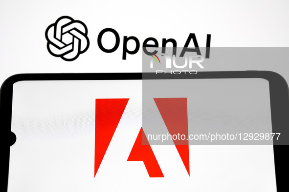 The Adobe logo appears on a smartphone screen, and the OpenAI logo displays as the background on a laptop screen in this photo illustration... by Nikolas Kokovlis/NurPhoto