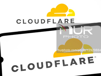 The Cloudflare logo appears on a smartphone screen and as the background on a laptop computer screen in this photo illustration in Athens, G... by Nikolas Kokovlis/NurPhoto