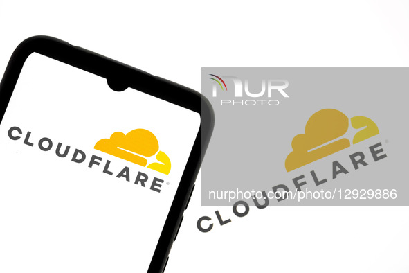 The Cloudflare logo appears on a smartphone screen and as the background on a laptop computer screen in this photo illustration in Athens, G... by Nikolas Kokovlis/NurPhoto