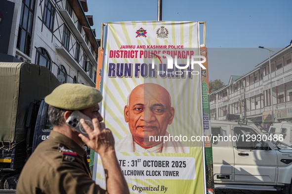 An Indian policeman walks past a poster featuring Sardar Vallabhbhai Patel, India's first Deputy Prime Minister, during the 'Run for Unity'... by Firdous Nazir/NurPhoto
