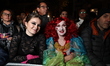 Revelers in costume wait to enter the parade route before the 52nd annual Village Hallowee...