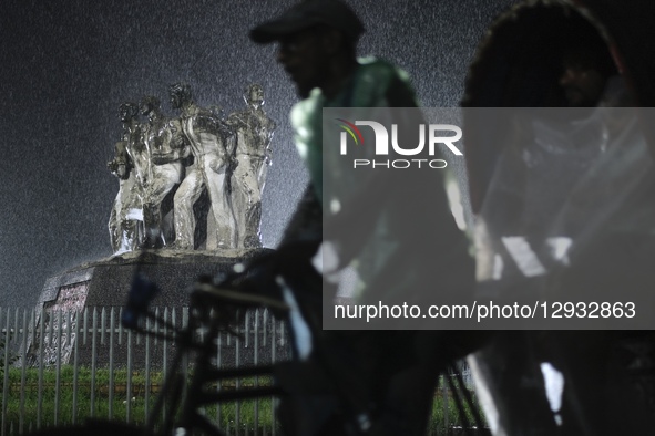 A rickshaw puller rides through the rain in Dhaka, Bangladesh, on November 1, 2025.  by Syed Mahamudur Rahman/NurPhoto