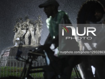 A rickshaw puller rides through the rain in Dhaka, Bangladesh, on November 1, 2025.  by Syed Mahamudur Rahman/NurPhoto