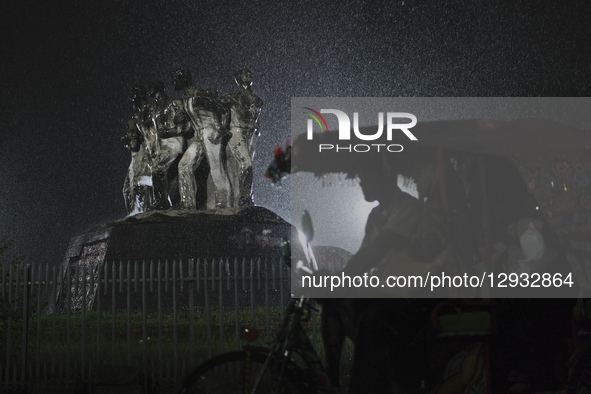 A rickshaw puller rides through the rain in Dhaka, Bangladesh, on November 1, 2025.  by Syed Mahamudur Rahman/NurPhoto