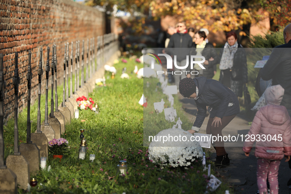 In Krakow, Poland, on November 1, 2025, people visit Rakowicki Cemetery during All Saints' Day. November 1 is celebrated in Catholicism as A... by Klaudia Radecka/NurPhoto