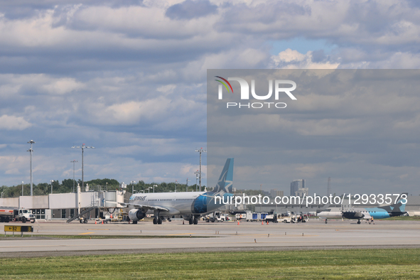 Airplanes are at Quebec City Jean Lesage International Airport in Quebec City, Quebec, Canada, on July 22, 2025.  by Creative Touch Imaging Ltd/NurPhoto