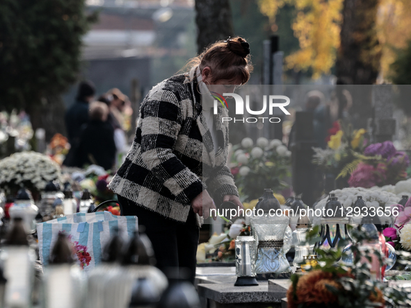 A woman visits graves on All Saints holiday in Ostrowiec Swietokrzyski in Poland on November 1, 2025. All Saints is one of the most importan... by Dominika Zarzycka/NurPhoto