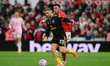 Luke Shaw of Manchester United is under pressure from Dan Ndoye of Nottingham Forest durin...