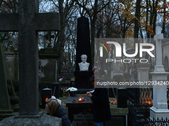 People visit their relatives' graves in the Powazki cemetery in Warsaw, Poland, on November 1, 2025.  by Aleksander Kalka/NurPhoto