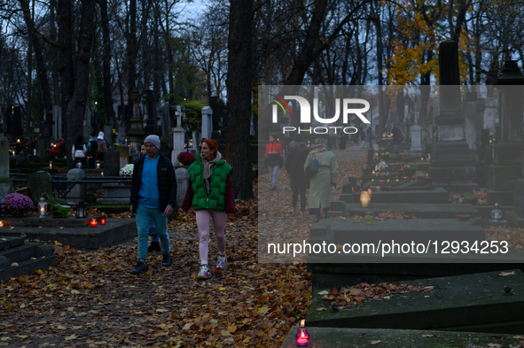 People visit their relatives' graves in the Powazki cemetery in Warsaw, Poland, on November 1, 2025.  by Aleksander Kalka/NurPhoto