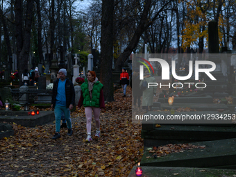 People visit their relatives' graves in the Powazki cemetery in Warsaw, Poland, on November 1, 2025.  by Aleksander Kalka/NurPhoto