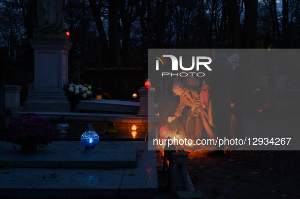 People visit their relatives' graves in the Powazki cemetery in Warsaw, Poland, on November 1, 2025.  by Aleksander Kalka/NurPhoto