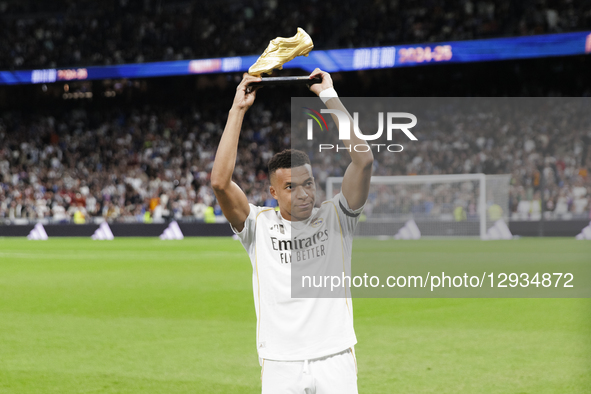 Kylian Mbappe of Real Madrid offers the Golden Boot trophy to Real Madrid fans during the La Liga 2025/26 match between Real Madrid and Vale... by Guillermo Martinez/NurPhoto