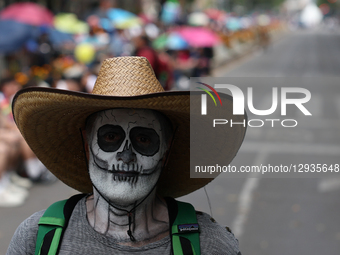 A person with painted face takes part in the Day of the Dead parade in Mexico City, Mexico on November 1, 2025.  by Jakub Porzycki/NurPhoto