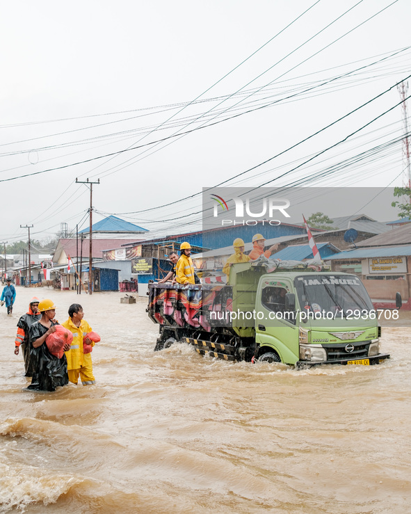 A male miner walks through floodwaters around the nickel industrial area owned by Indonesia Weda Bay Industrial Park (IWIP) in Weda Bay, on... by Muhammad Fauzy/NurPhoto
