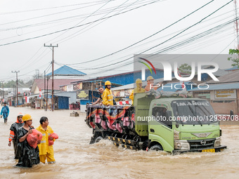 A male miner walks through floodwaters around the nickel industrial area owned by Indonesia Weda Bay Industrial Park (IWIP) in Weda Bay, on... by Muhammad Fauzy/NurPhoto