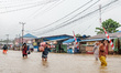 A male miner walks through floodwaters around the nickel industrial area owned by Indonesi...