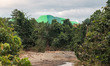 A brown river is suspected of being polluted by mining waste from upstream around the nick...