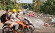 Workers ride motorbikes on damaged roads around the nickel industrial area owned by Indone...
