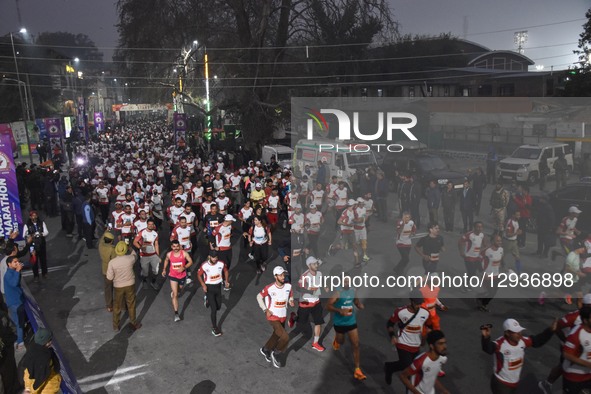 Participants run during the Kashmir Marathon in Srinagar, Jammu and Kashmir, on November 2, 2025. Kashmir hosts its second international mar...