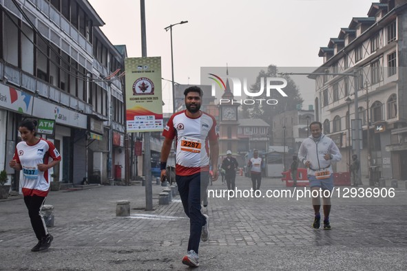 Participants run near the Clock Tower (Ghanta Ghar) during the Kashmir Marathon in Srinagar, Jammu and Kashmir, on November 2, 2025. Kashmir... by Firdous Nazir/NurPhoto