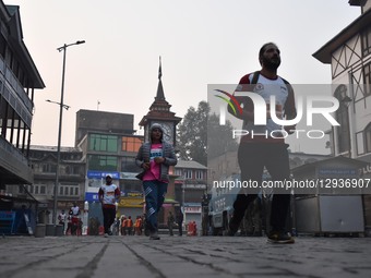 Participants run near the Clock Tower (Ghanta Ghar) during the Kashmir Marathon in Srinagar, Jammu and Kashmir, on November 2, 2025. Kashmir... by Firdous Nazir/NurPhoto