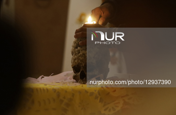 A view of a skull inside a chapel in the Sierra Madre Sur of Mexico, where dozens of people gather for a Day of the Dead procession. They pl... by Gerardo Vieyra/NurPhoto