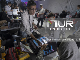 Young Iranian robotics specialists prepare their robot to participate in the Robot Warriors competition, held during Iran's 2025 Tech Olympi... by Morteza Nikoubazl/NurPhoto