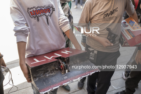 A young Iranian robotics specialist carries his robot to participate in the Robot Warriors competition in Tehran, Iran, on October 29, 2025.... by Morteza Nikoubazl/NurPhoto
