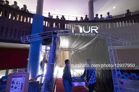 Two Iranian robotics specialists carry their robot to participate in the Robot Warriors competition, held during Iran's 2025 Tech Olympics a... by Morteza Nikoubazl/NurPhoto