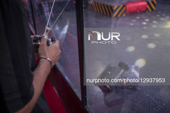 A young Iranian robotics specialist controls his robot while participating in the Robot Warriors competition during Iran's 2025 Tech Olympic... by Morteza Nikoubazl/NurPhoto