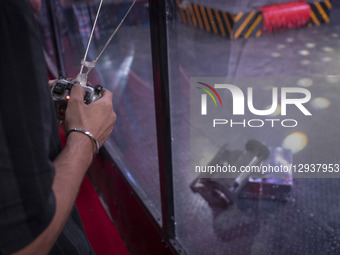 A young Iranian robotics specialist controls his robot while participating in the Robot Warriors competition during Iran's 2025 Tech Olympic... by Morteza Nikoubazl/NurPhoto