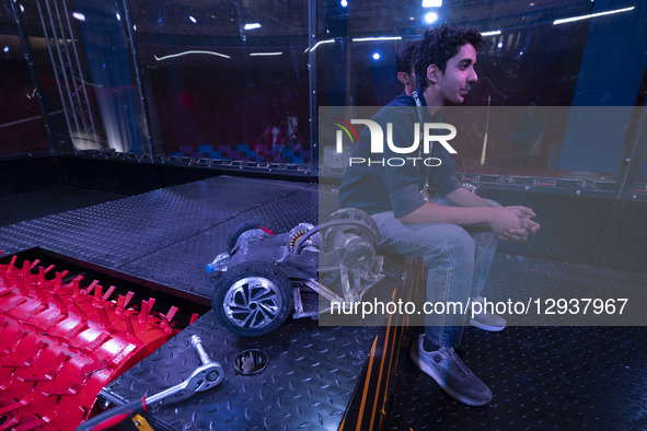 An Iranian robotics specialist sits next to his robot after losing a match in the Robot Warriors competition, held during Iran's 2025 Tech O... by Morteza Nikoubazl/NurPhoto