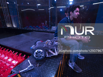 An Iranian robotics specialist sits next to his robot after losing a match in the Robot Warriors competition, held during Iran's 2025 Tech O... by Morteza Nikoubazl/NurPhoto