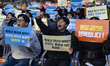 Participants hold placards reading ''Religious freedom is a basic civil right'' and chant...