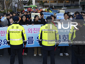 Members and youth of the Family Federation for World Peace and Unification, also known as the Unification Church, march through downtown Seo... by Chris Jung/NurPhoto