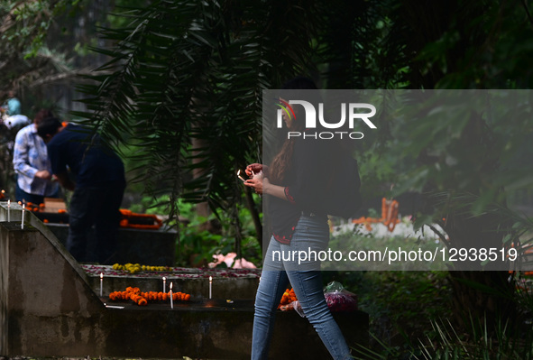 A Christian woman offers prayers over the grave of a family member at the Rajapur Cemetery in Prayagraj, India, on November 2, 2025. All Sou... by Sanjay Kanojia/NurPhoto