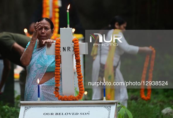 A Christian woman offers prayers over the grave of a family member at the Rajapur Cemetery in Prayagraj, India, on November 2, 2025, on the... by Sanjay Kanojia/NurPhoto