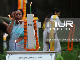 A Christian woman offers prayers over the grave of a family member at the Rajapur Cemetery in Prayagraj, India, on November 2, 2025, on the... by Sanjay Kanojia/NurPhoto
