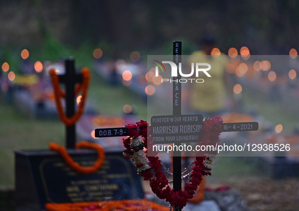 A Christian woman offers prayers over the grave of a family member at the Rajapur Cemetery in Prayagraj, India, on November 2, 2025. All Sou... by Sanjay Kanojia/NurPhoto