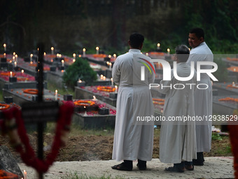 Indian Christian priests offer prayers on tombs during All Souls Day in Prayagraj, India, on November 2, 2025, at Rajapur Cemetery. All Soul... by Sanjay Kanojia/NurPhoto
