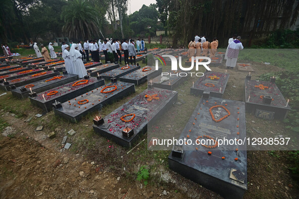 Indian Christian priests offer prayers on tombs during All Souls Day in Prayagraj, India, on November 2, 2025, at Rajapur Cemetery. All Soul... by Sanjay Kanojia/NurPhoto