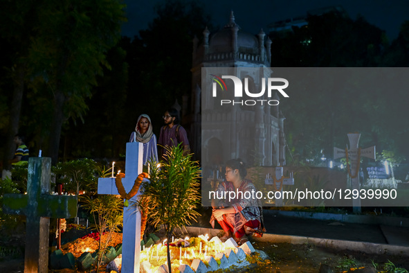 Christian devotees light candles by the grave of a relative during All Souls' Day at a graveyard in Dhaka, Bangladesh, on November 2, 2025.  by Zabed Hasnain Chowdhury/NurPhoto